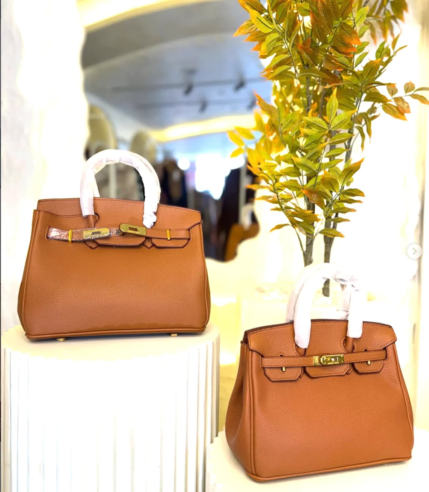 Two camel top-handle bags